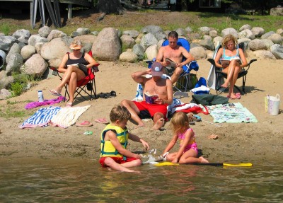 Relaxing on the beach up north at a lake.  The good life.